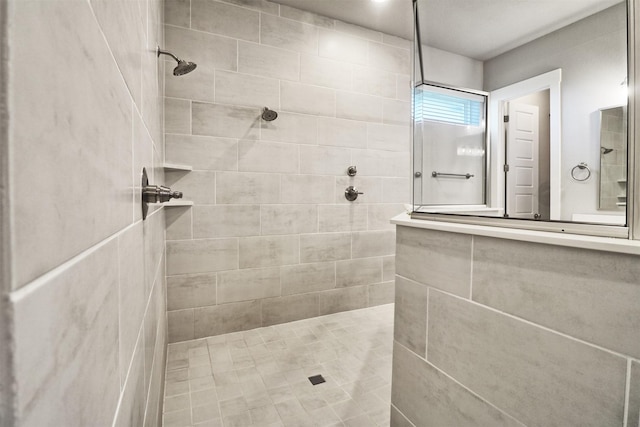 bathroom with tiled shower