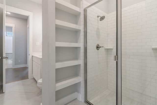 bathroom with vanity, toilet, and an enclosed shower