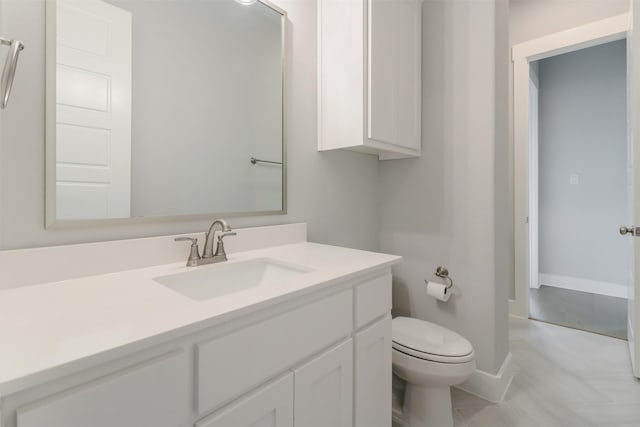 bathroom with tile patterned flooring, vanity, and toilet