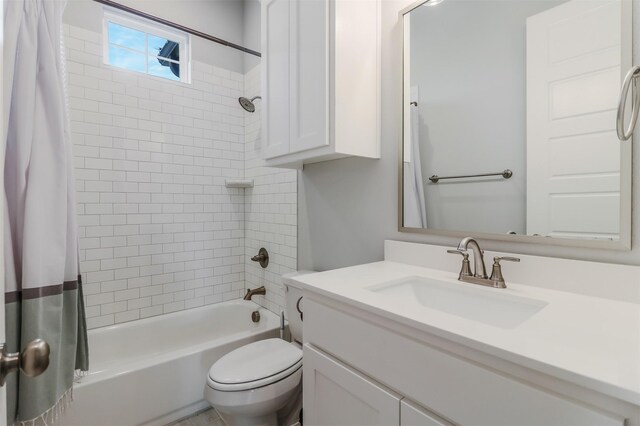 full bathroom with toilet, vanity, and shower / tub combo with curtain