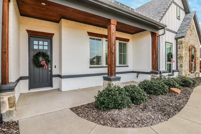 view of exterior entry with a porch