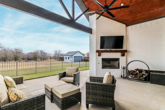 view of patio / terrace featuring an outdoor living space with a fireplace and ceiling fan