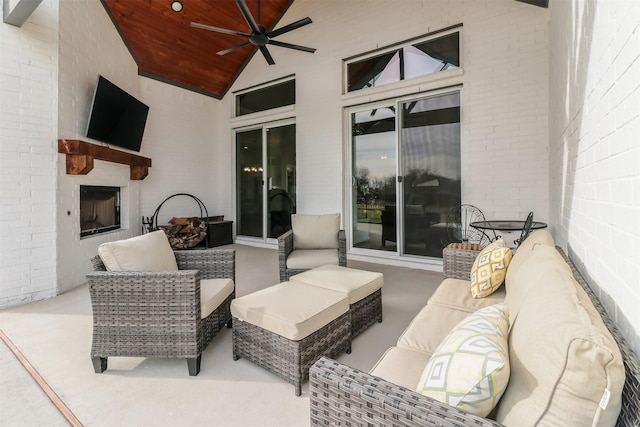 view of patio featuring an outdoor living space with a fireplace and ceiling fan