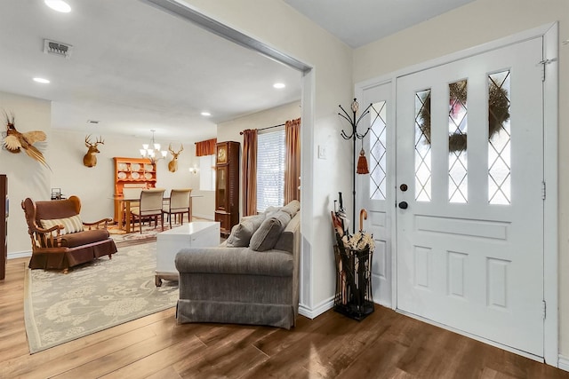 entrance foyer with a notable chandelier and hardwood / wood-style flooring