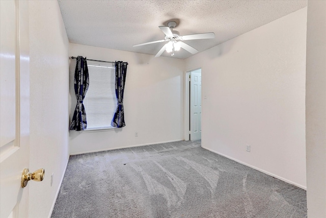 unfurnished room with light carpet, ceiling fan, and a textured ceiling