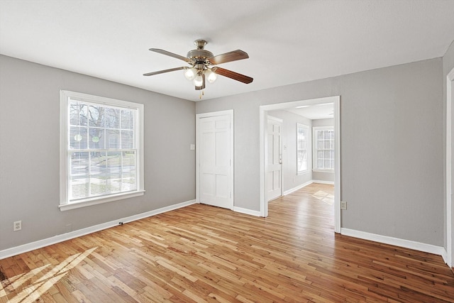 empty room featuring ceiling fan and light hardwood / wood-style floors