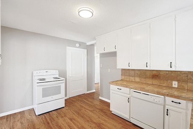 kitchen featuring tile counters, light hardwood / wood-style flooring, backsplash, white appliances, and white cabinets