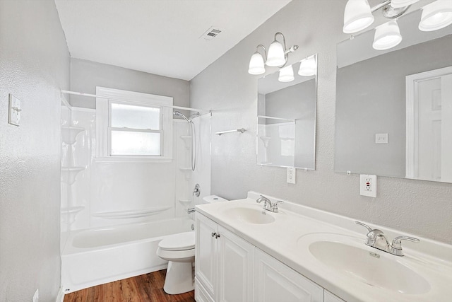 full bathroom with hardwood / wood-style floors, vanity, toilet, and bathtub / shower combination