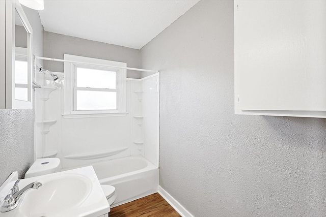 full bathroom featuring vanity, toilet, wood-type flooring, and tub / shower combination