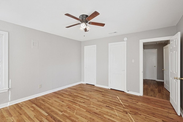 unfurnished bedroom with ceiling fan and hardwood / wood-style floors