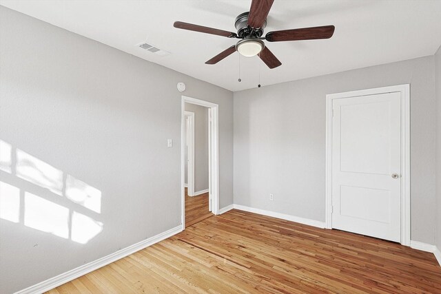 empty room featuring hardwood / wood-style floors and ceiling fan