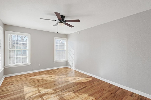 unfurnished room with light wood-type flooring, plenty of natural light, and ceiling fan