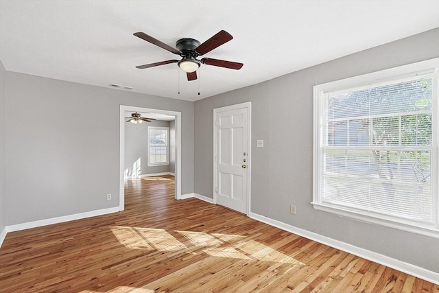 unfurnished room featuring ceiling fan and hardwood / wood-style floors