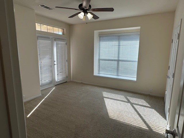 carpeted empty room featuring ceiling fan