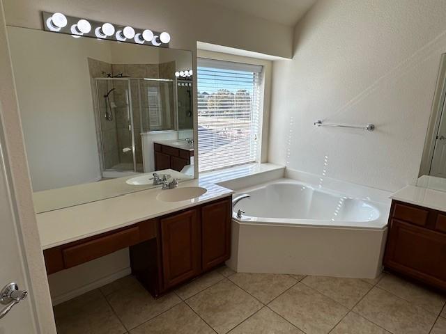 bathroom featuring vanity, separate shower and tub, and tile patterned floors