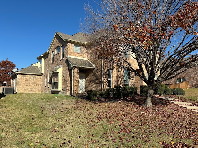 view of home's exterior featuring cooling unit and a yard