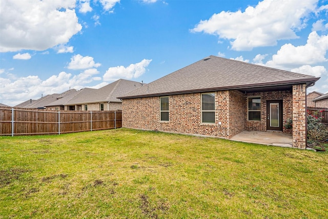 rear view of property with a lawn and a patio area