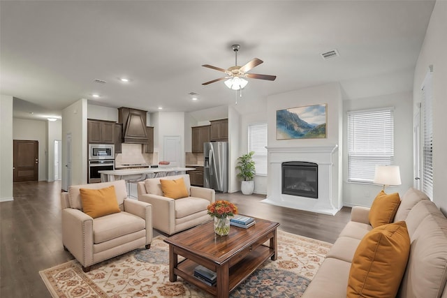 living room with light hardwood / wood-style flooring and ceiling fan