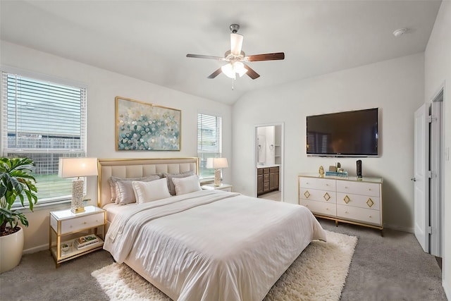 carpeted bedroom with vaulted ceiling, ensuite bath, and ceiling fan