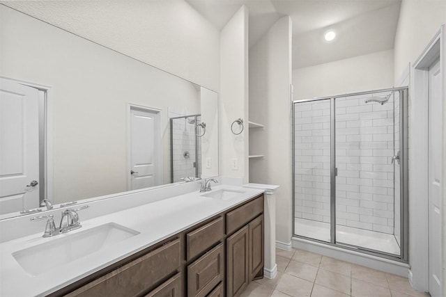 bathroom with tile patterned flooring, vanity, and a shower with door