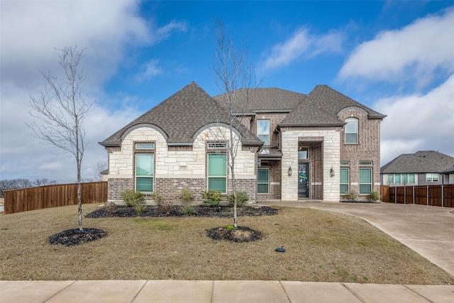 french country style house featuring a front lawn