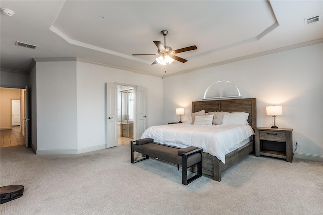 bedroom featuring a raised ceiling, crown molding, light colored carpet, and ceiling fan