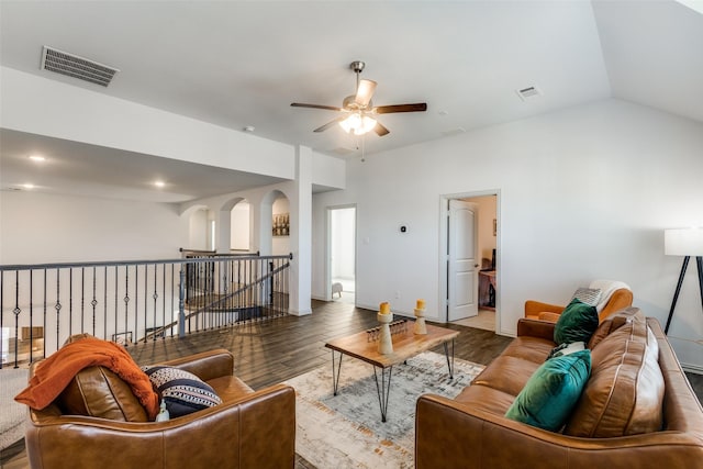 living room featuring dark hardwood / wood-style flooring, lofted ceiling, and ceiling fan