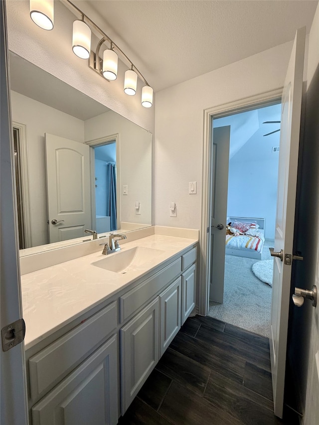 bathroom with vanity, wood-type flooring, and a textured ceiling