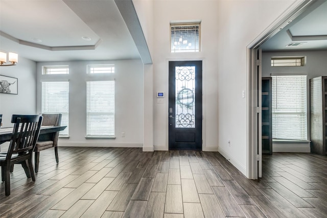 foyer with a raised ceiling