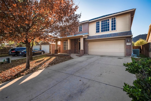 front of property featuring a garage and central air condition unit