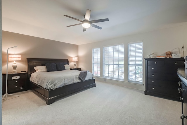 bedroom featuring light carpet and ceiling fan