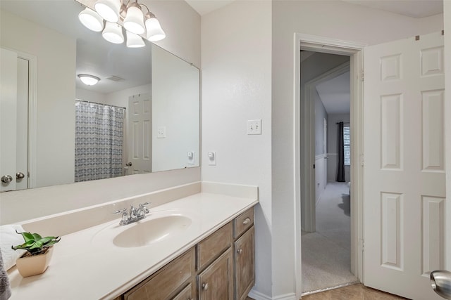 bathroom featuring a shower with curtain, vanity, and a chandelier