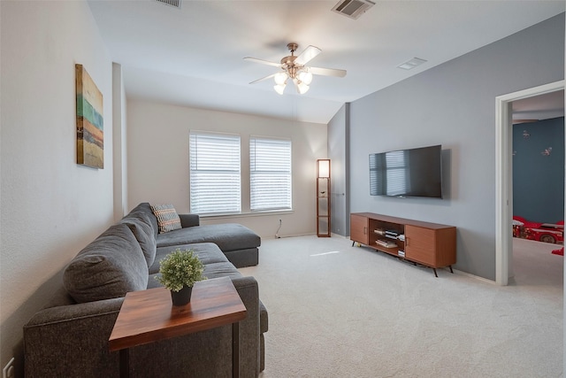 carpeted living room with ceiling fan and lofted ceiling