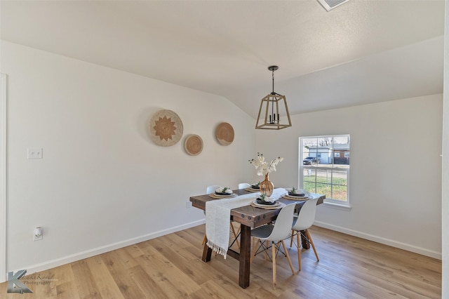 dining space featuring light hardwood / wood-style flooring and lofted ceiling