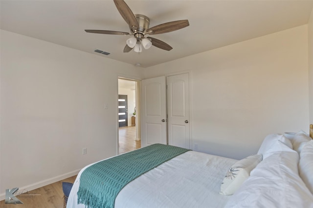 bedroom with ceiling fan and light hardwood / wood-style floors