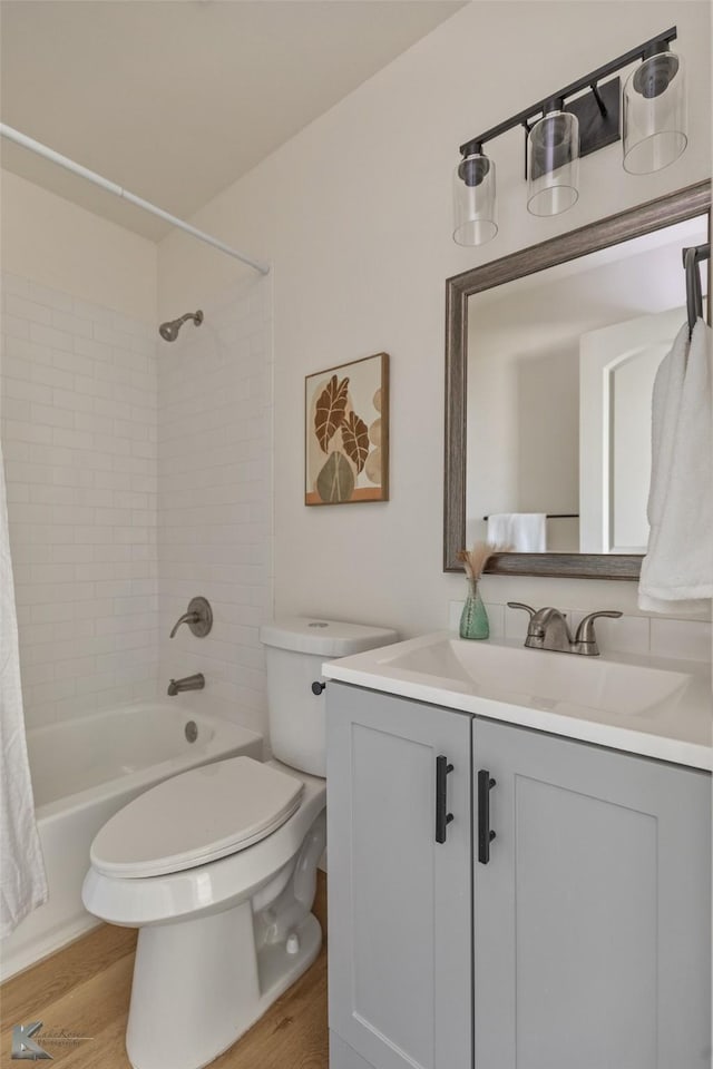 full bathroom with wood-type flooring, vanity, toilet, and shower / bath combination with curtain