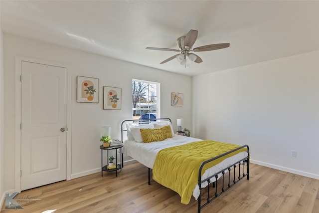 bedroom with ceiling fan and light hardwood / wood-style floors