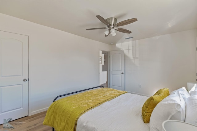 bedroom with light wood-type flooring and ceiling fan