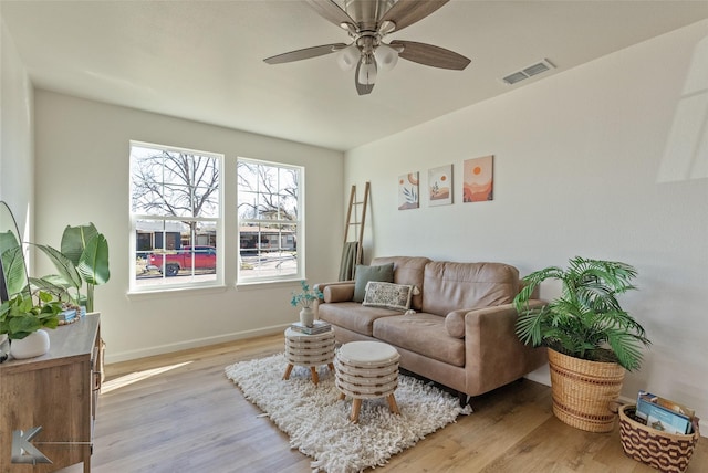 living room with ceiling fan and light hardwood / wood-style flooring