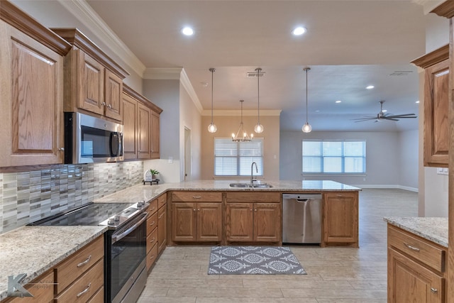 kitchen featuring ceiling fan with notable chandelier, decorative light fixtures, kitchen peninsula, and appliances with stainless steel finishes