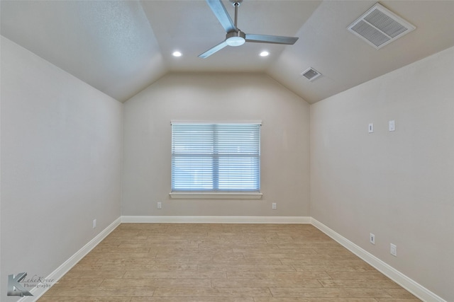 spare room featuring ceiling fan, light hardwood / wood-style floors, and lofted ceiling