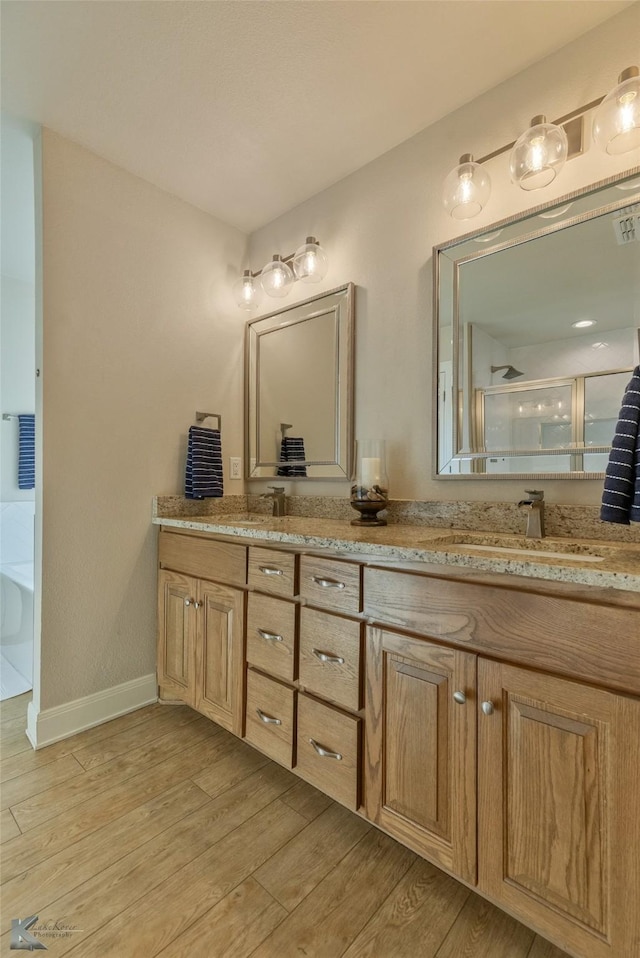 bathroom with wood-type flooring, vanity, and separate shower and tub