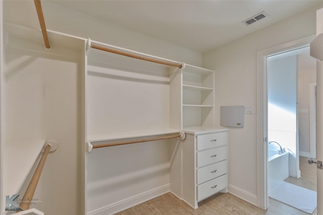 walk in closet featuring light hardwood / wood-style floors