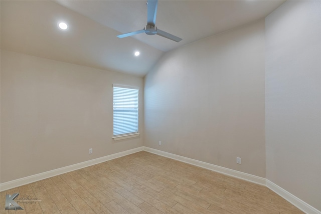 empty room with ceiling fan, light hardwood / wood-style flooring, and lofted ceiling