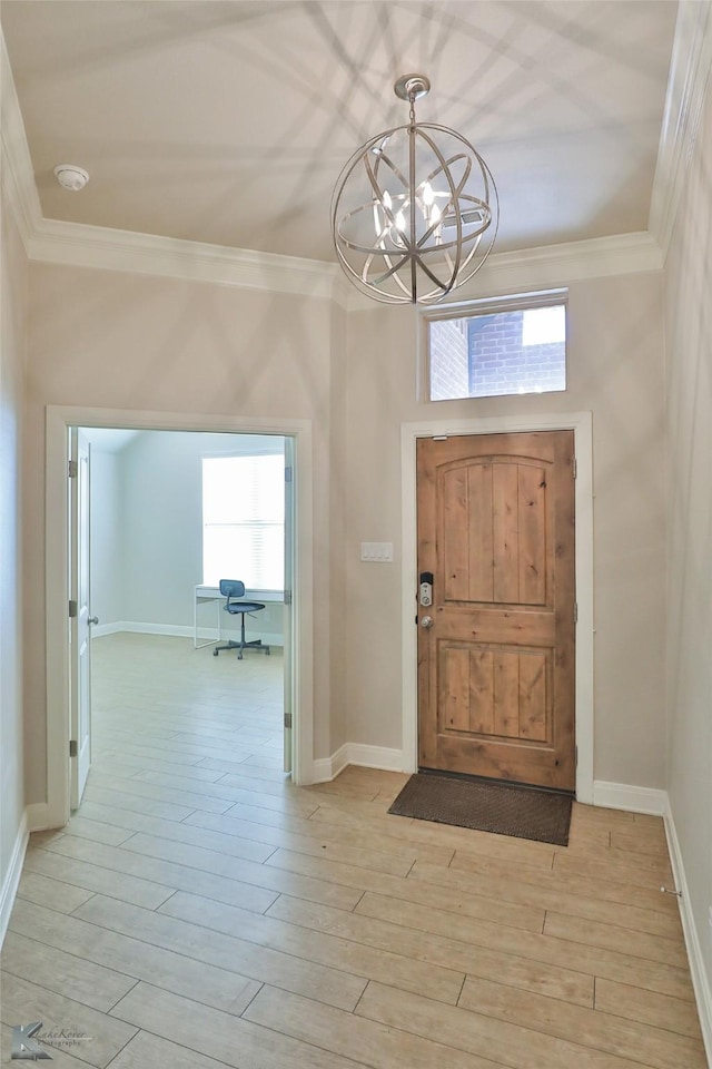 entrance foyer featuring light hardwood / wood-style flooring, a notable chandelier, and ornamental molding