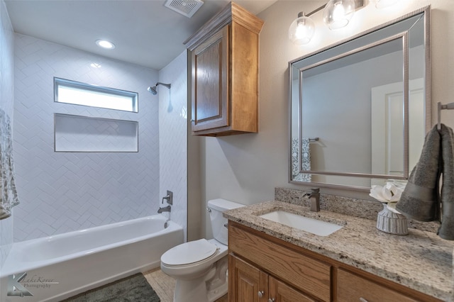 full bathroom featuring tile patterned floors, vanity, toilet, and tiled shower / bath