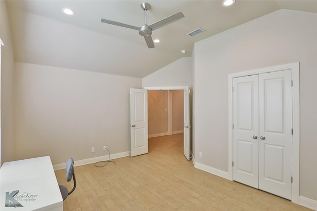 home office with ceiling fan, light hardwood / wood-style floors, and lofted ceiling