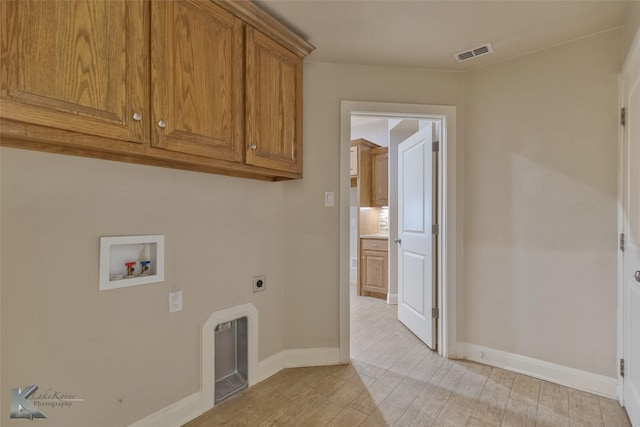 washroom featuring cabinets, hookup for a washing machine, light wood-type flooring, and hookup for an electric dryer