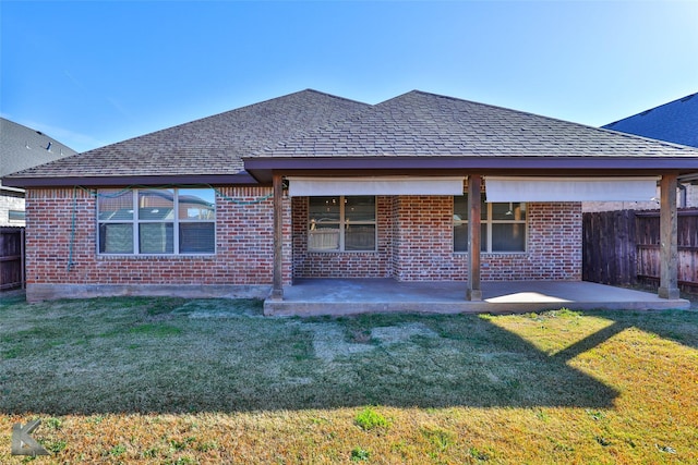 rear view of property featuring a patio area and a yard