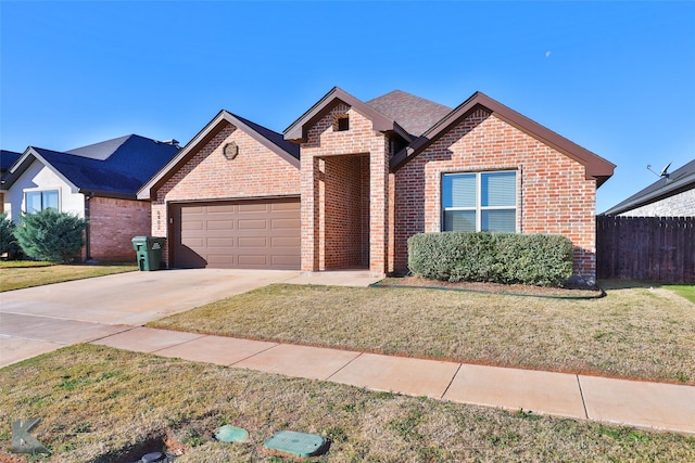 view of front of property featuring a front yard and a garage